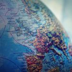 Detailed close-up of a globe showing parts of Europe and the Atlantic Ocean.