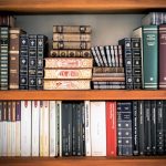 A detailed view of a bookshelf with vintage and classic books arranged neatly, offering a historic ambiance.